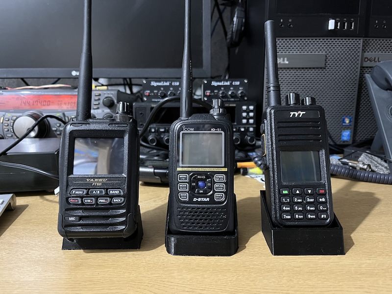 Three handheld transceivers in 3d printed stands