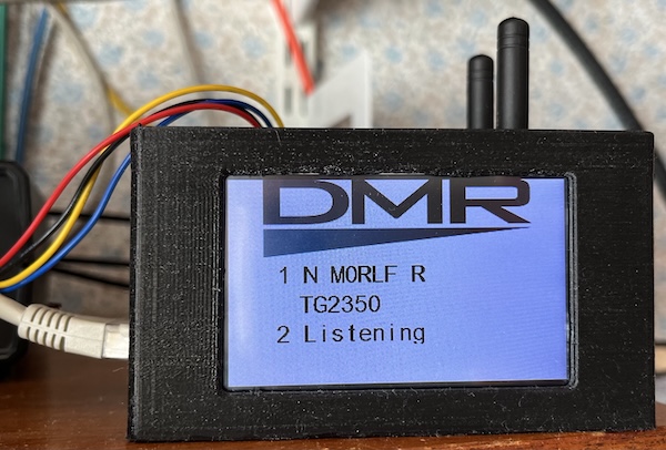 A black 3D printed box with a 3.2" Nextion display showing DMR traffic