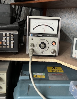 A photo of a HP 435B power meter showing a reading of around 0.6 on a 30mW scale.