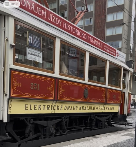 A photo of an older style tram in red and white.